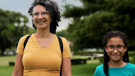 Woman-and-girl-walking-on-grass